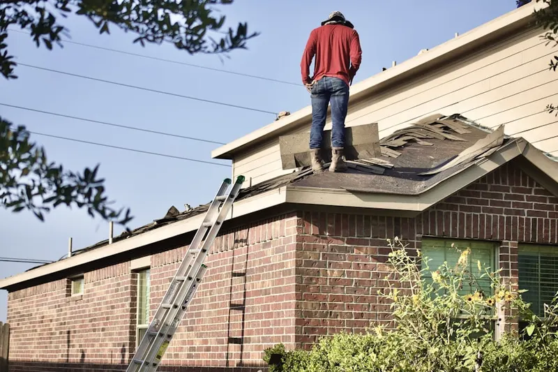 Professional roofer working on a residential roof in Moncure Corner